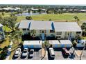 Overhead view of condos near a golf course and pond, with parking and well-kept landscaping at 410 Cerromar S Cir # 240, Venice, FL 34293
