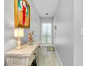 Entry hallway featuring light gray walls, accent table, and decor at 410 Cerromar S Cir # 240, Venice, FL 34293