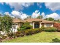 Charming one-story home with a well-maintained lawn, lush landscaping and an attached garage at 4443 Abcor Rd, North Port, FL 34286