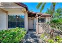 Inviting front entrance with lush landscaping, walkway, and a charming facade at 5641 Mashie Cir, North Port, FL 34287
