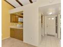 Open kitchen and foyer area features tile floors, neutral paint, and ample natural light at 5641 Mashie Cir, North Port, FL 34287