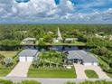 A serene aerial shot of a waterfront home, highlighting its manicured lawn and tranquil surroundings at 1025 Cheshire St, Port Charlotte, FL 33953