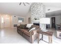 Bright living room showcasing a stone fireplace, neutral decor, and tiled floors at 10289 60Th N Cir, Pinellas Park, FL 33782