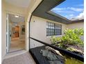 Inviting entryway with decorative tile flooring, stone accents, and a view into the kitchen at 1039 Marlene St, Port Charlotte, FL 33952