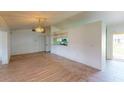Bright living room with neutral walls, wood-look flooring, and an open floor plan at 1351 Washington Dr, Englewood, FL 34224