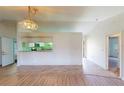 Bright living room with an open floor plan and a pass through to the kitchen at 1351 Washington Dr, Englewood, FL 34224