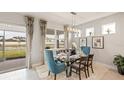 Dining room featuring elegant lighting, a glass top table, and large windows with a view to the outside at 15968 Crofton Springs Way, Port Charlotte, FL 33953
