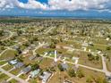 Panoramic aerial view showcasing the property's location in a tranquil residential neighborhood near the water at 16094 Ortega Dr, Punta Gorda, FL 33955