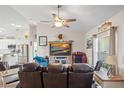 Cozy living room with leather seating, TV, and an abundance of natural light at 16094 Ortega Dr, Punta Gorda, FL 33955