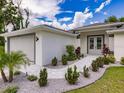 Welcoming single-story home with a gray brick walkway and beautifully landscaped front garden at 17130 Elder St, Port Charlotte, FL 33954
