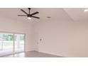 Bright living room featuring a ceiling fan, large sliding doors, and neutral wall color at 17130 Elder St, Port Charlotte, FL 33954