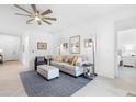 Bright living room features neutral decor, tile flooring, and a ceiling fan at 1734 Saddlewood Cir, Port Charlotte, FL 33953