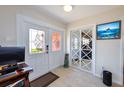 Bright foyer featuring a decorative glass front door, interior mirrored closet doors, and modern tile flooring at 190 Casa Ln, Punta Gorda, FL 33950