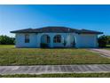 Charming single-story home boasting a neatly maintained lawn and a one-car attached garage at 2271 Alton Rd, Port Charlotte, FL 33952