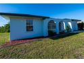 An attractive single-story home featuring an attached garage and a lush green lawn at 2271 Alton Rd, Port Charlotte, FL 33952