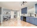 Bright kitchen featuring blue cabinets, stainless appliances, and a breakfast table set near french doors at 2420 Linton Ln, Port Charlotte, FL 33952