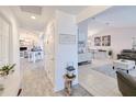 Bright and airy hallway leading to the living room and dining area, showcasing the open floor plan at 25379 Paladin Ln, Punta Gorda, FL 33983