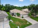 An aerial view showcasing this home's tile roof, two-car garage, landscaped yard, and neighborhood at 26111 Feathersound Dr, Punta Gorda, FL 33955