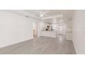 Bright living room featuring a modern ceiling fan and light grey flooring at 27128 Aloha Dr, Punta Gorda, FL 33955