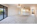 A bright living room with neutral carpet and an opening into the kitchen at 3256 White Ibis Ct # 24A, Punta Gorda, FL 33950