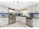 Bright kitchen featuring stainless steel appliances, granite countertops, and sleek, updated cabinets at 4089 Yucatan Cir, Port Charlotte, FL 33948
