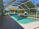Inviting screened-in pool with a sunshade, perfect for leisurely swims and outdoor enjoyment at 4089 Yucatan Cir, Port Charlotte, FL 33948