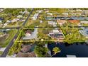 Stunning aerial view of a waterfront property featuring a spacious yard and a private dock at 4317 Mccullough St, Port Charlotte, FL 33948