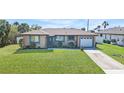 Charming single-story home with a well-maintained lawn and attached garage at 4358 Pates St, Port Charlotte, FL 33948