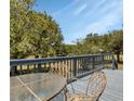 Close up of outdoor deck with metal table and chairs overlooking the backyard at 6421 Grove Blvd, Punta Gorda, FL 33982