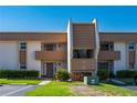 A manicured exterior elevation of a two-story condo building with parking and colorful landscaping at 1080 Bal Harbor Blvd # 12C, Punta Gorda, FL 33950