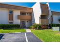 Charming exterior view of condo unit 12 with a well-kept lawn and flowering shrubs at 1080 Bal Harbor Blvd # 12C, Punta Gorda, FL 33950