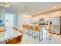 Open kitchen with stainless steel appliances, granite countertops, and counter seating at 111 Rain Lily Ave, Spring Hill, FL 34609