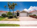 Beautiful one-story home with a brick driveway, two-car garage, well-maintained lawn and Florida landscaping at 11666 Parrotfish St, Venice, FL 34292