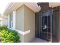 Close-up view of the front entry with a decorative security door and beige exterior at 11666 Parrotfish St, Venice, FL 34292