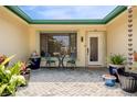 Inviting covered front porch with seating and a view of the home's lush landscaping at 155 Donna Ct, Punta Gorda, FL 33950