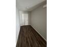 Hallway with wood floors leading to a door at 16280 Minorca Dr, Punta Gorda, FL 33955