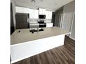 Bright kitchen features a large white island, stainless steel appliances, and white cabinets for a modern feel at 16280 Minorca Dr, Punta Gorda, FL 33955
