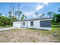 Single-story house featuring a two car garage, newly painted exterior, and landscaped front yard at 17197 Russell Ave, Port Charlotte, FL 33954