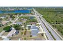 Aerial view of the home showcasing the lot, location near a highway and pond, and nearby neighborhood at 19468 Edgewater Dr, Port Charlotte, FL 33948