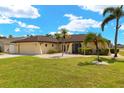 Charming single-story home with palm trees, neutral exterior, and a well-maintained lawn at 2152 Taiwan Ct, Punta Gorda, FL 33983