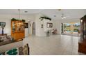Spacious living room with tile flooring, vaulted ceilings, and a view of the screened-in lanai at 2152 Taiwan Ct, Punta Gorda, FL 33983