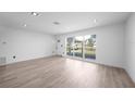 Bright and airy living room with new flooring, recessed lighting and modern windows at 2166 Beacon Dr, Port Charlotte, FL 33952