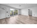 Living room featuring updated flooring, fresh paint, and modern finishes, with a view of the front yard at 2166 Beacon Dr, Port Charlotte, FL 33952