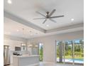 Open kitchen with stainless appliances, island with pendant lighting, and natural light from pool view at 223 Australian Dr, Rotonda West, FL 33947