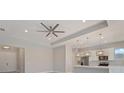 Bright open-concept living room adjacent to modern kitchen with views, recessed lighting and ceiling fan at 223 Australian Dr, Rotonda West, FL 33947