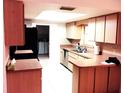 Bright kitchen featuring stainless steel appliances and ample countertop space for meal preparation at 23220 Rountree Ave, Port Charlotte, FL 33980