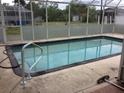 A refreshing screened-in pool with ample space for relaxation and recreation at 23220 Rountree Ave, Port Charlotte, FL 33980