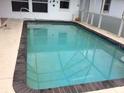 Inviting in-ground pool with cool blue water and a tile surround, perfect for summertime fun at 23220 Rountree Ave, Port Charlotte, FL 33980