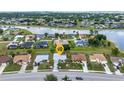 Aerial view of a beautiful property near a lake surrounded by a lush neighborhood at 2442 Rio De Janeiro Ave, Punta Gorda, FL 33983