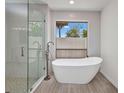 Modern bathroom featuring a glass shower and stand alone tub at 2442 Rio De Janeiro Ave, Punta Gorda, FL 33983